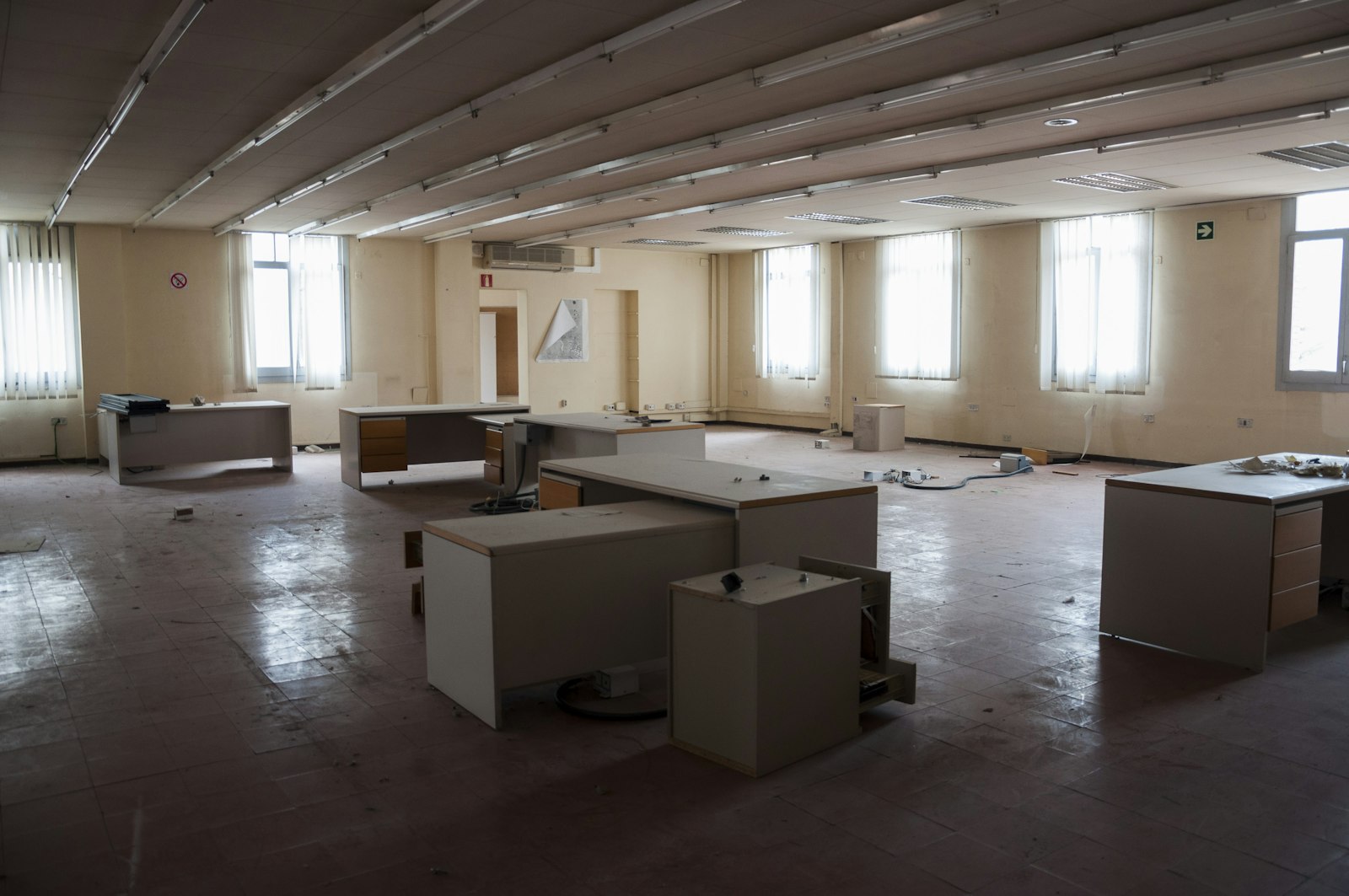 A cleared office with abandoned desks and no people