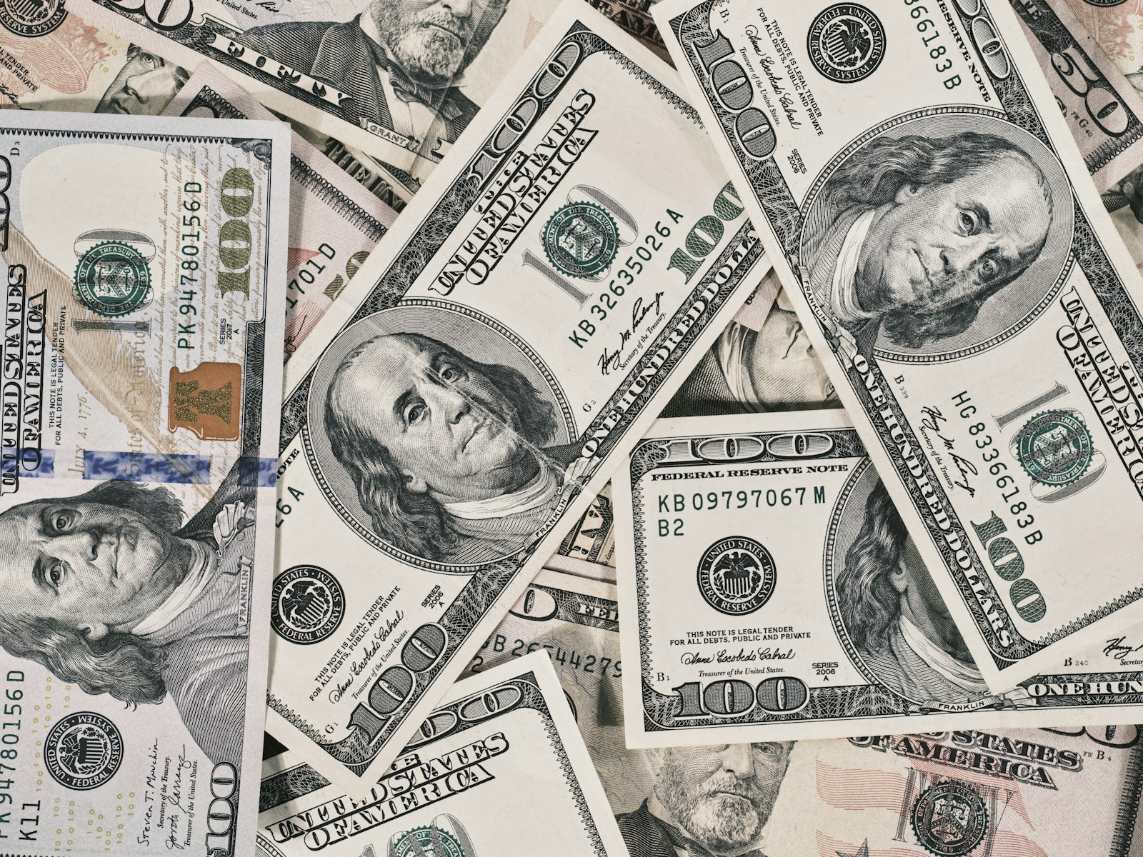 Scattered United States fifty and one hundred dollar banknotes