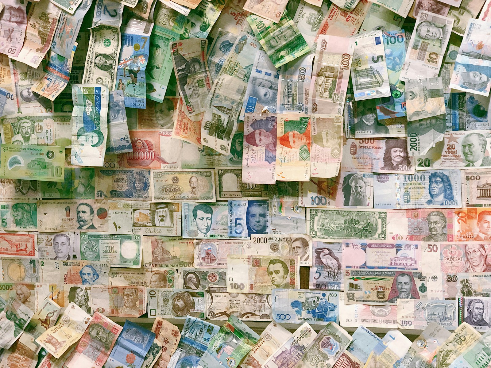 Ten dollar banknotes on a brown wooden table