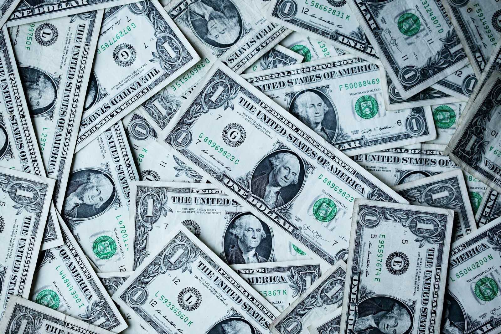 One dollar banknotes spread across a surface