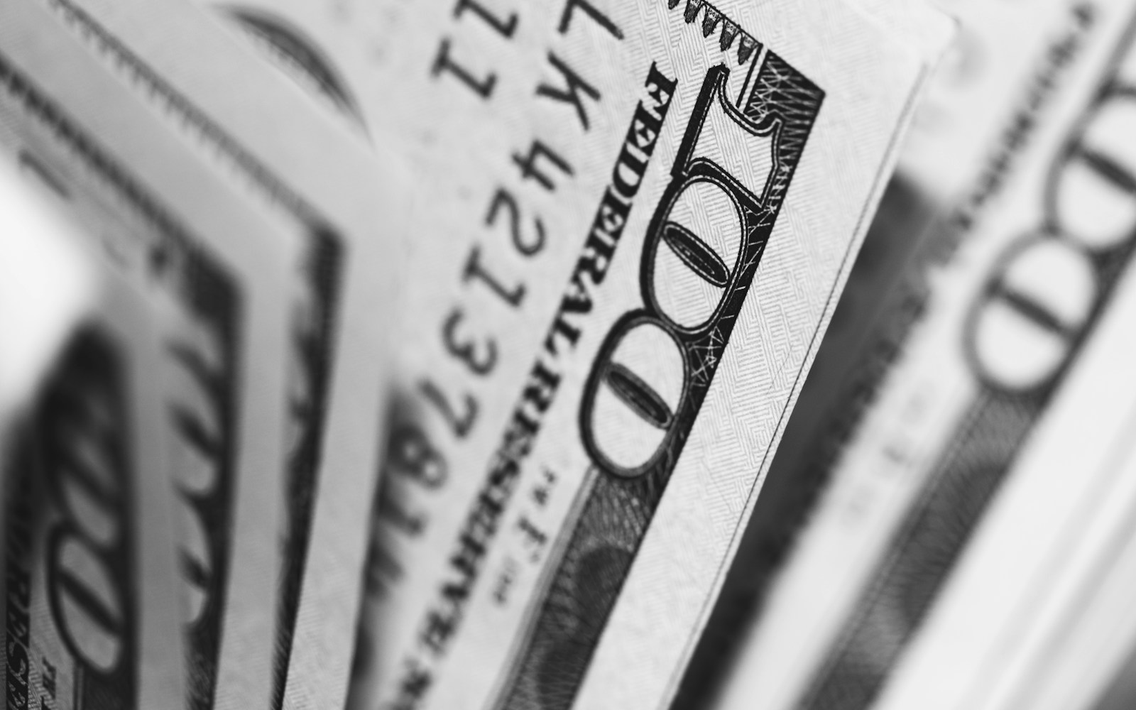 A close-up of fanned one hundred dollar bills